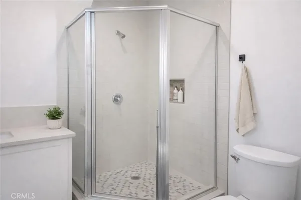 a bathroom with a shower a toilet and a sink