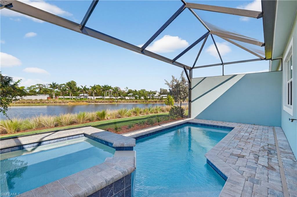 8813 Yucatan Court Naples, FL 34113 - Photo 11 of 43 View of pool featuring a hot tub, a patio, and a water view