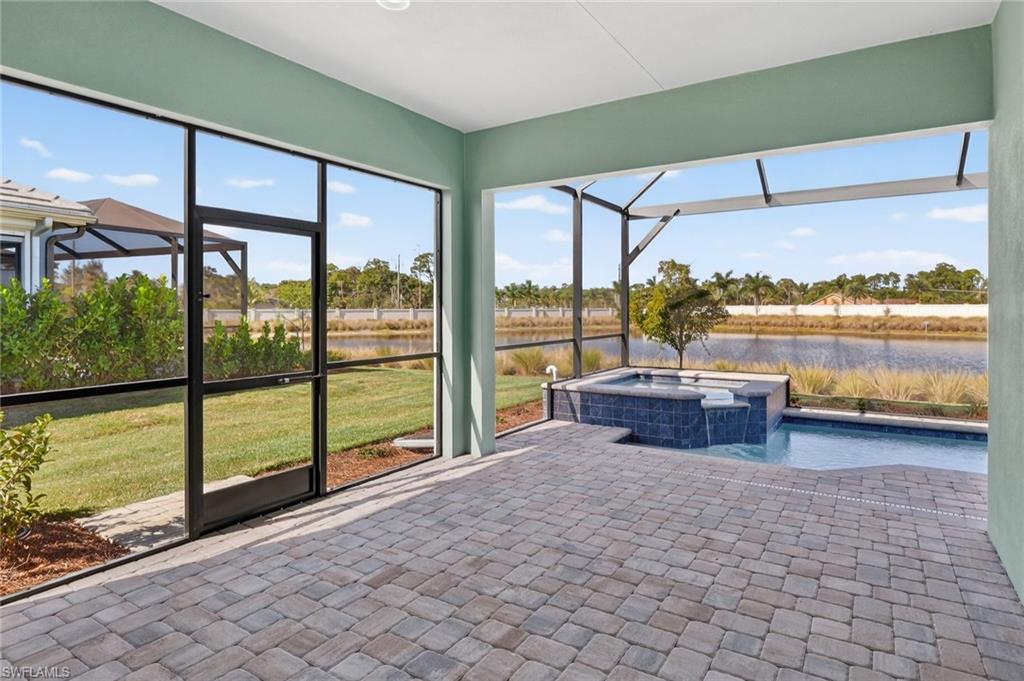8813 Yucatan Court Naples, FL 34113 - Photo 12 of 43 Screened patio with a hot tub and water view