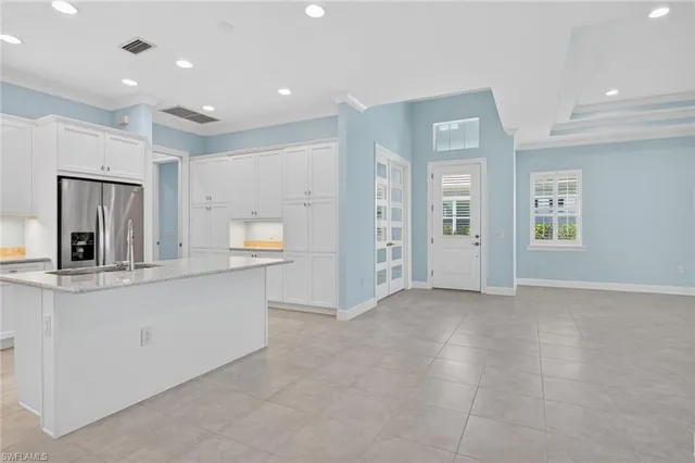 a kitchen with stainless steel appliances granite countertop a sink a stove a refrigerator a sink a counter space and cabinets