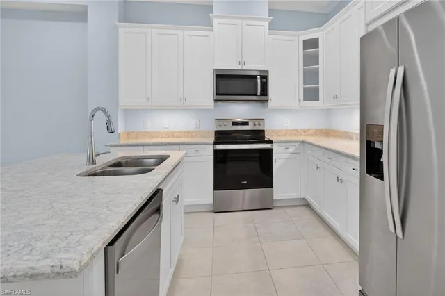 a kitchen with a sink stove and refrigerator