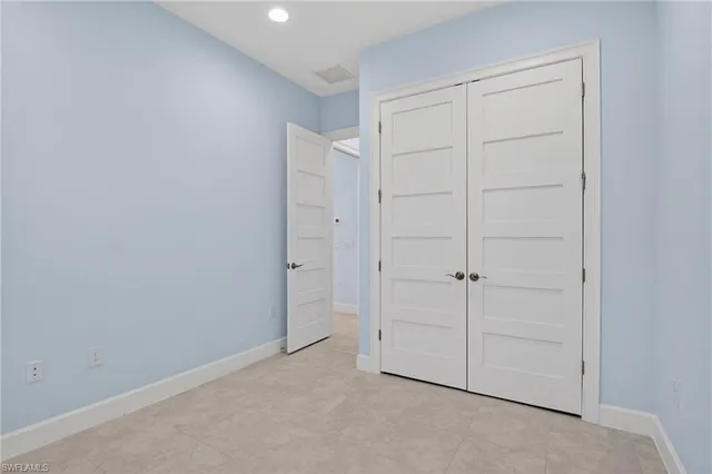 a bathroom with a granite countertop sink a toilet and a mirror