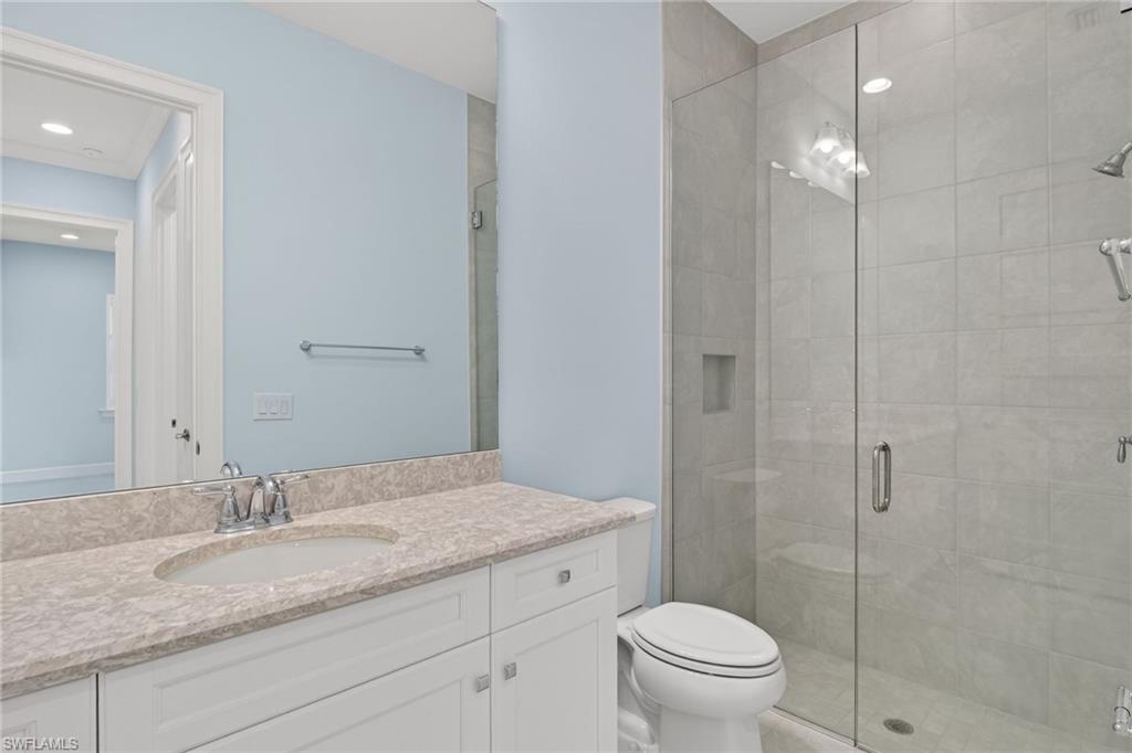 8813 Yucatan Court Naples, FL 34113 - Photo 29 of 43 Full bathroom with vanity, a stall shower, and recessed lighting