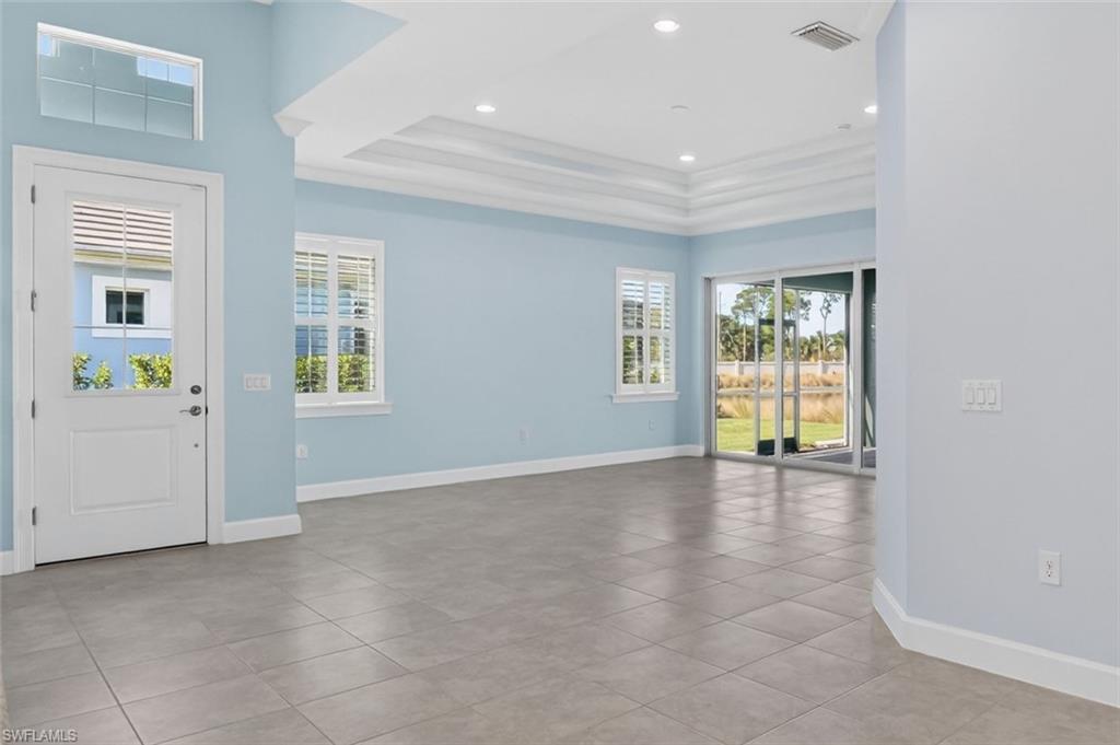 8813 Yucatan Court Naples, FL 34113 - Photo 3 of 43 Entryway with natural light, a raised ceiling, recessed lighting, and light tile patterned floors