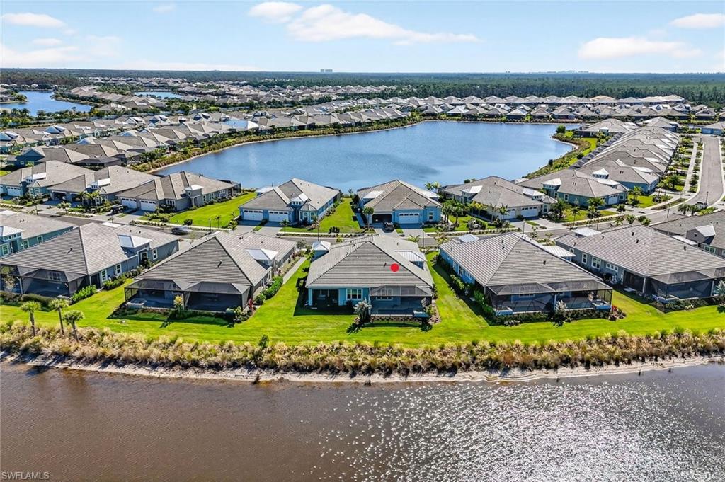 8813 Yucatan Court Naples, FL 34113 - Photo 34 of 43 Aerial view of residential area with a nearby body of water