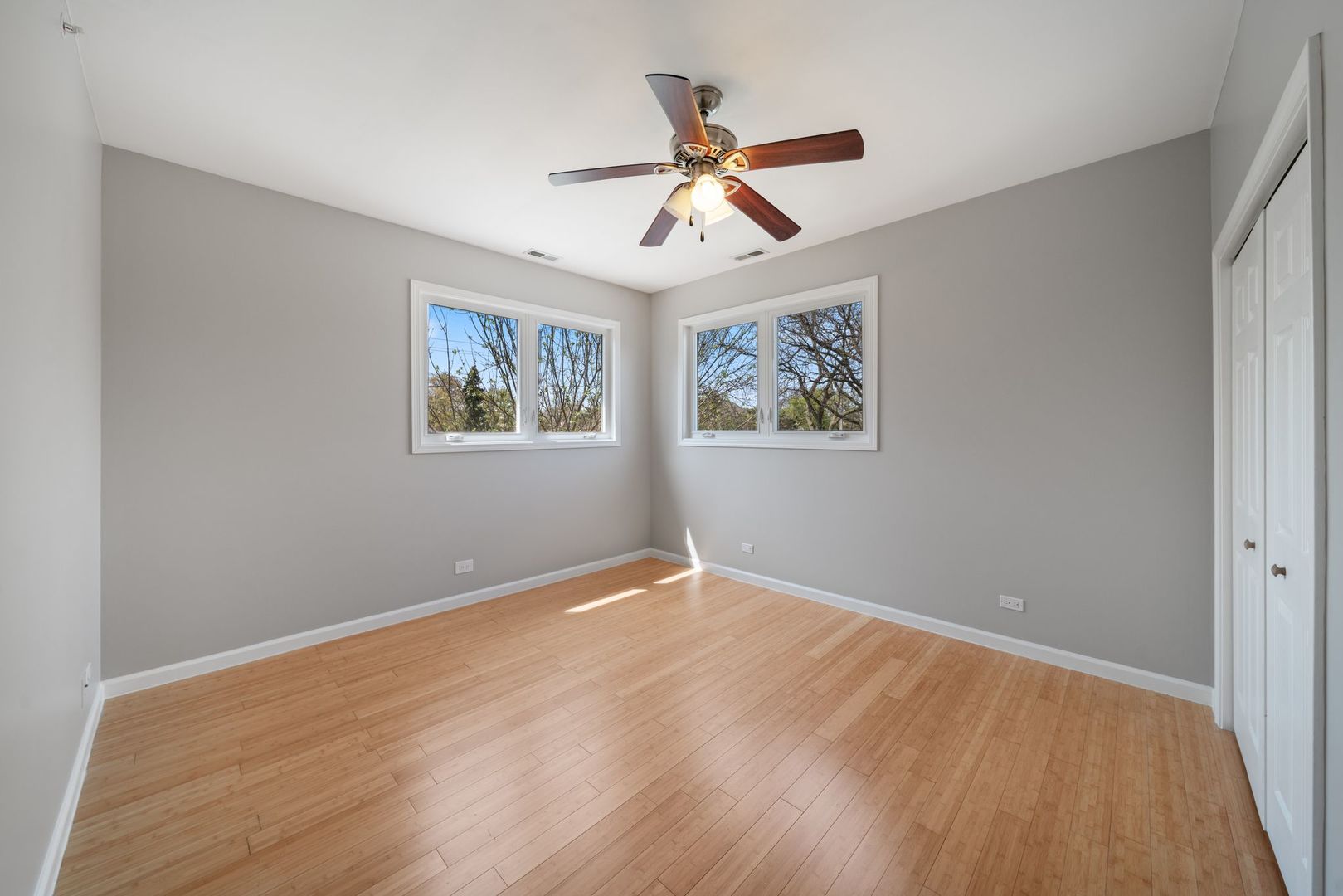 701 Oakton Street Park Ridge, IL 60068 - Photo 32 of 59 a view of an empty room with wooden floor and a window