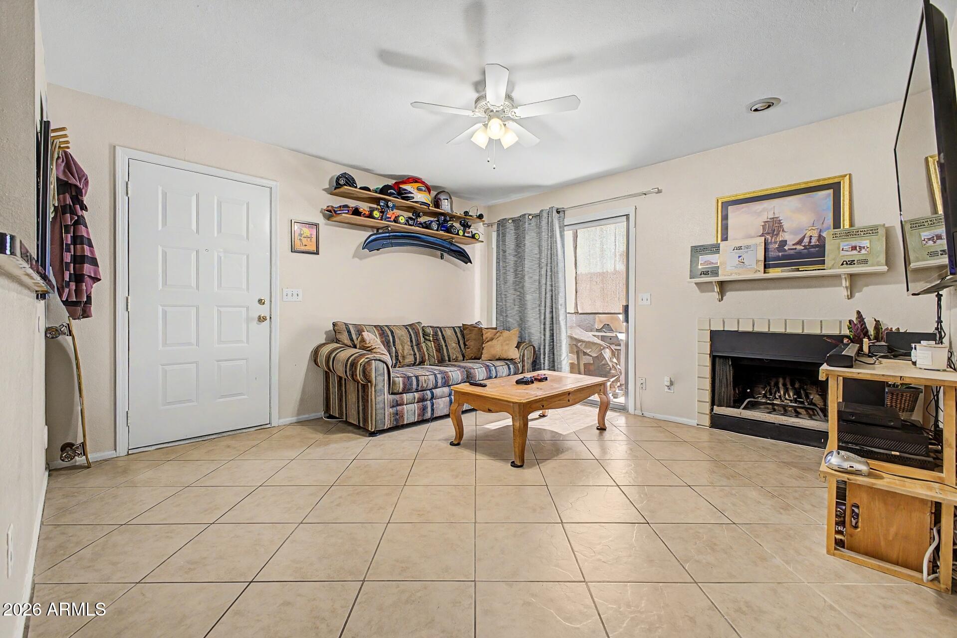 533 West Guadalupe Road, Unit 1104 Mesa, AZ 85210 - Photo 3 of 20 a living room with furniture and a fireplace