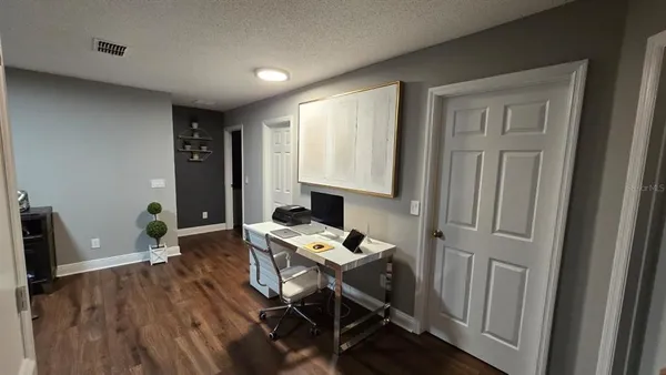 a view of a bedroom with wooden floor