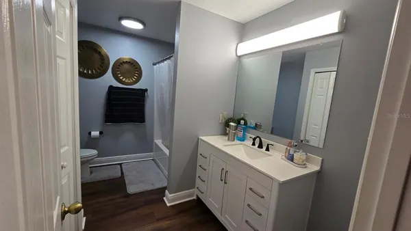 a bedroom with a flat screen tv and a bed