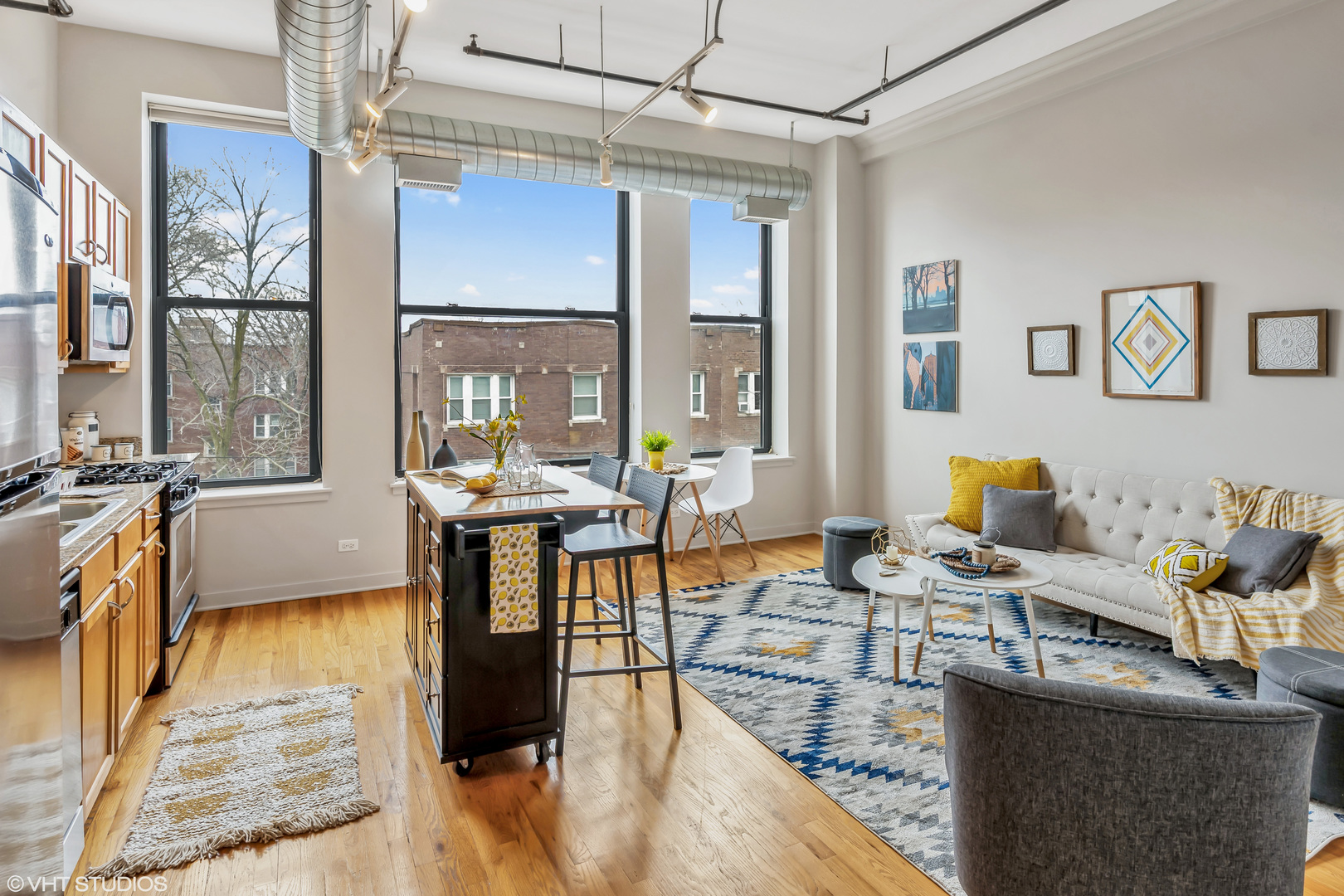 4715 North Racine Avenue, Unit 303 Chicago, IL 60640 - Photo 2 of 18 a living room with furniture a large window and potted plants