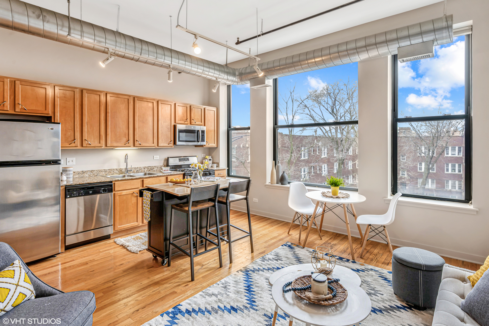 4715 North Racine Avenue, Unit 303 Chicago, IL 60640 - Photo 5 of 18 a kitchen with a table chairs stove and cabinets