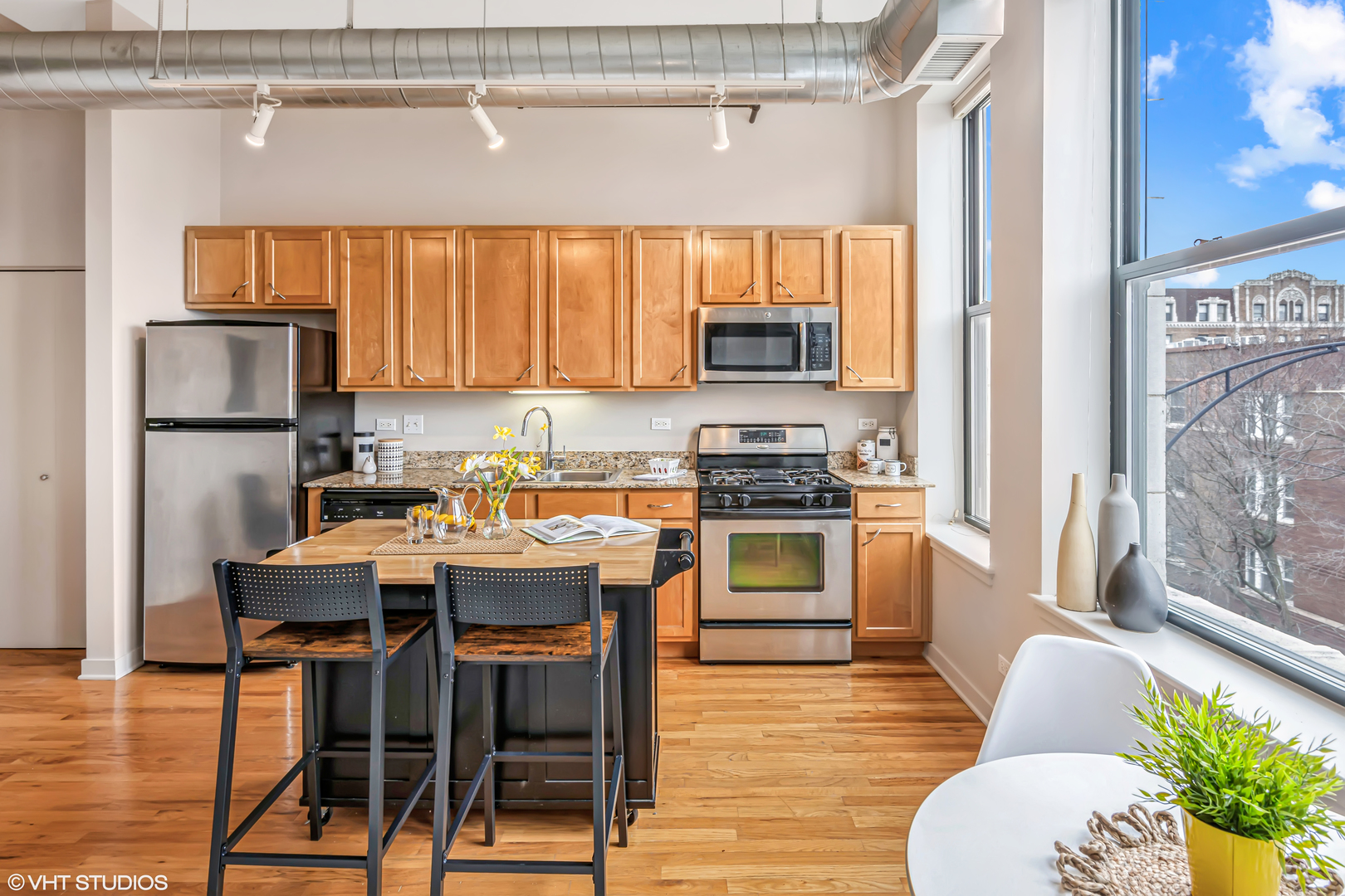 4715 North Racine Avenue, Unit 303 Chicago, IL 60640 - Photo 6 of 18 a kitchen with a sink a microwave and refrigerator