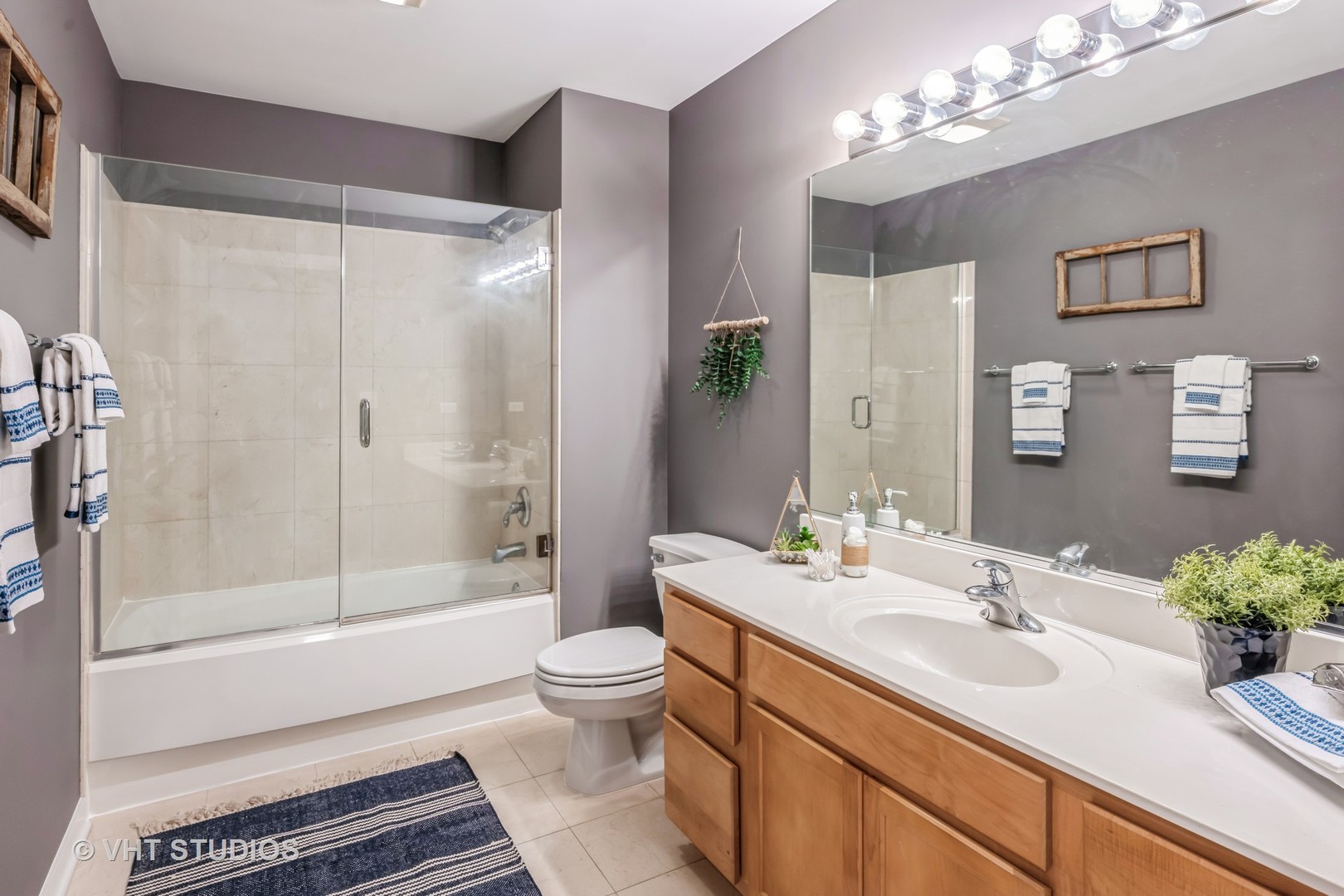 4715 North Racine Avenue, Unit 303 Chicago, IL 60640 - Photo 10 of 18 a bathroom with a sink a toilet and shower