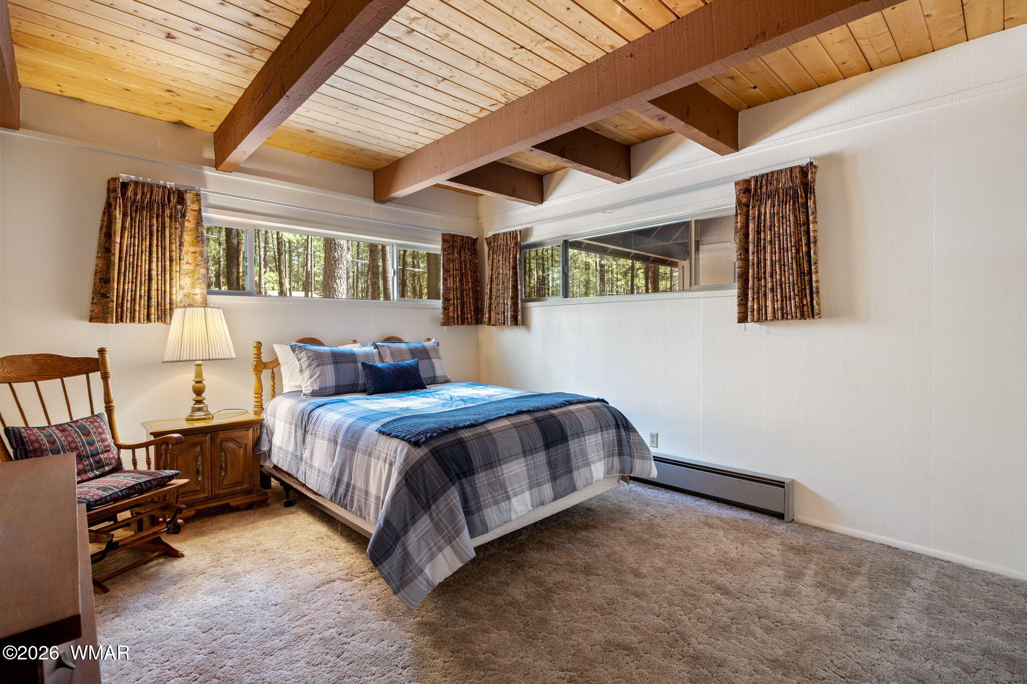 7456 Geronimo Road Pinetop, AZ 85935 - Photo 13 of 35 a bed sitting in a room next to a larger window