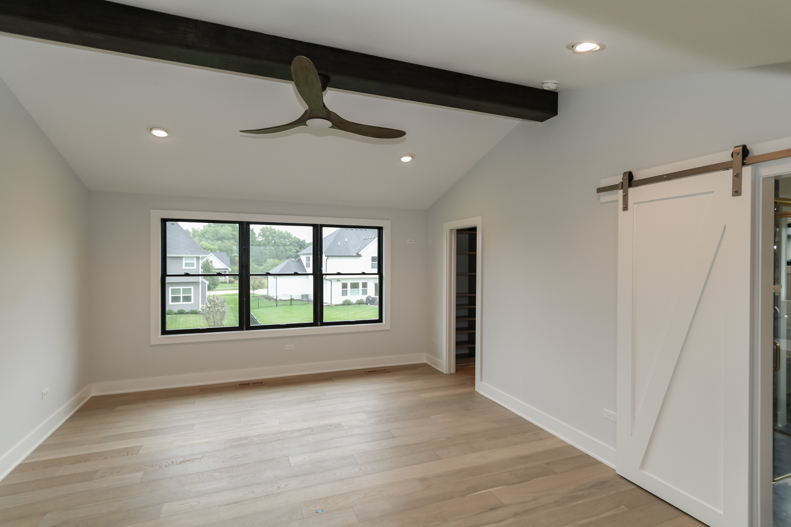 26005 Forrester Drive Plainfield, IL 60585 - Photo 18 of 19 a view of an empty room with a window and wooden floor