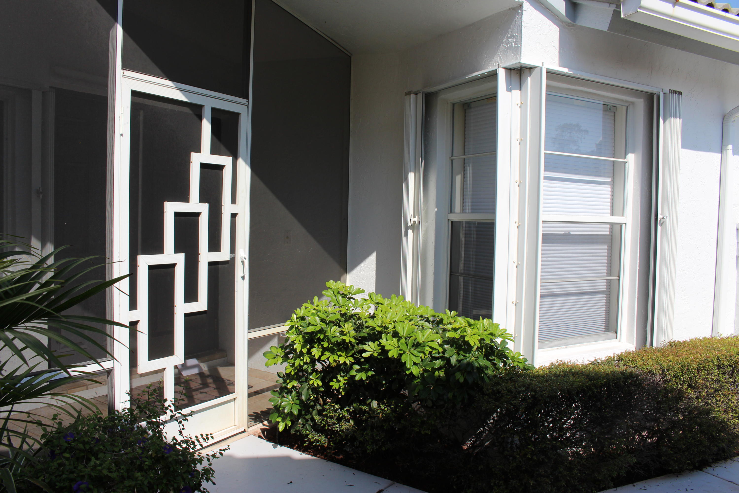 10012 Country Brook Road Boca Raton, FL 33428 - Photo 3 of 25 a couple of potted plants in front of door