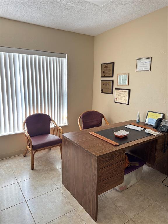 1025 West Oak Ridge Road Orlando, FL 32839 - Photo 4 of 4 a view of a workspace with furniture and a window
