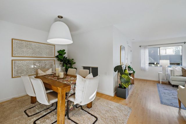 a view of a dining room with furniture window and flowerpot