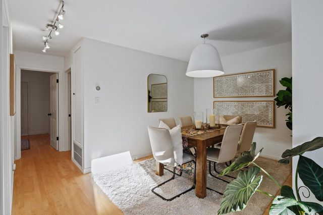 a view of a dining room with furniture and chandelier