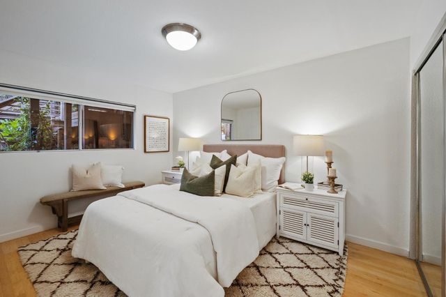 a bedroom with a bed and a night stand