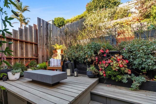 a wooden bench sitting in front of a building