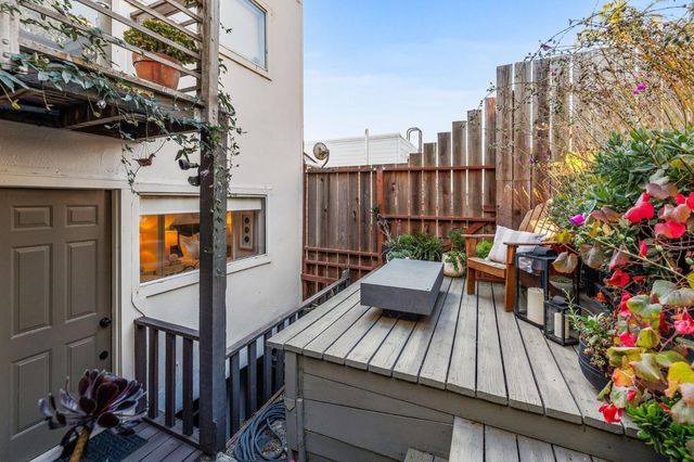 a view of balcony with two chairs and a potted plant