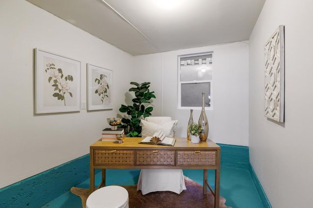 a view of a room that has a table and chair