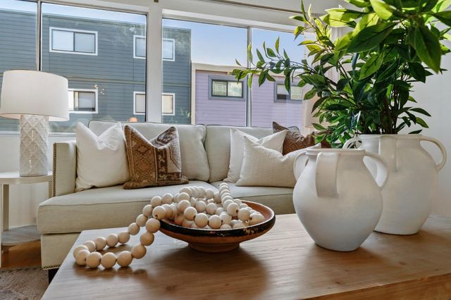 a living room with furniture and a potted plant
