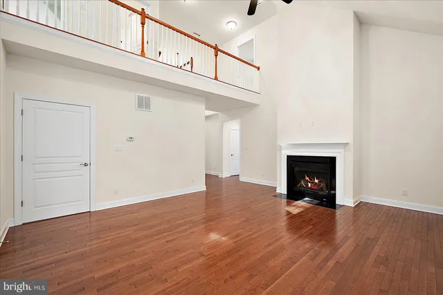a kitchen with kitchen island a sink stainless steel appliances and wooden floor