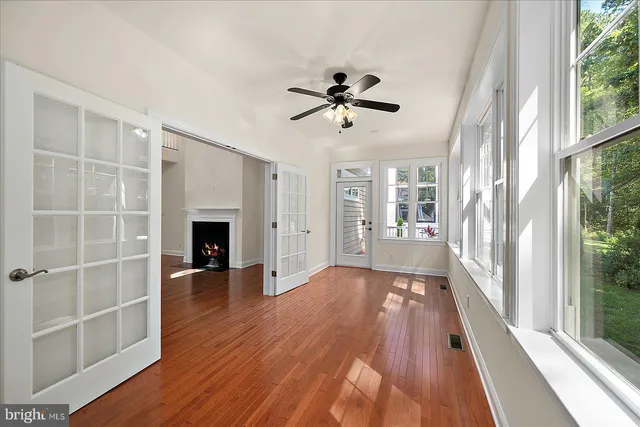 a kitchen with stainless steel appliances granite countertop a refrigerator a sink and a wooden floor