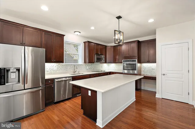 an empty room with fan and entrance