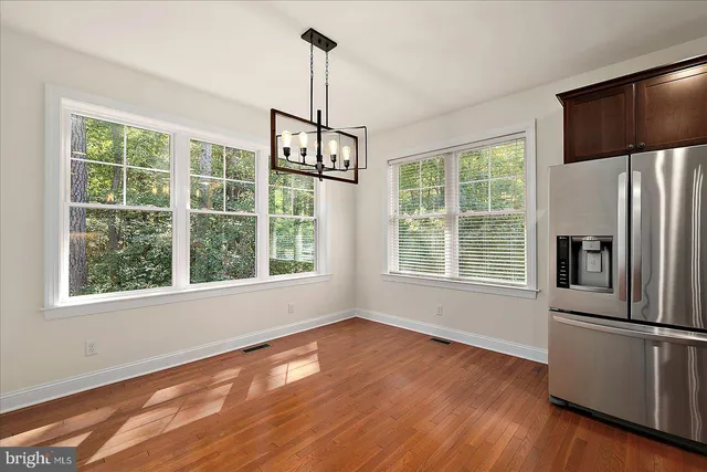 a view of a wooden deck next to a yard
