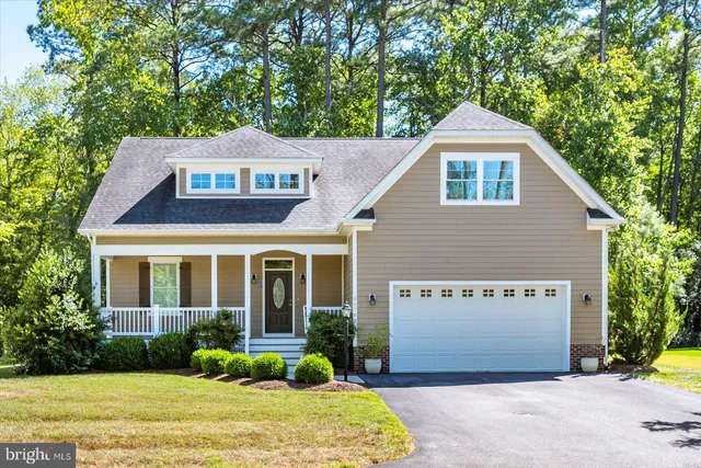 a kitchen with stainless steel appliances kitchen island granite countertop a refrigerator a sink dishwasher a oven with white cabinets and wooden floor