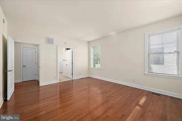 a front view of a house with plants