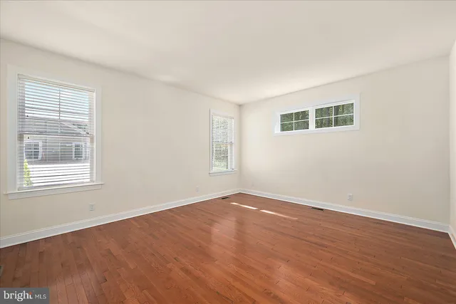 a view of a house with a yard and potted plants