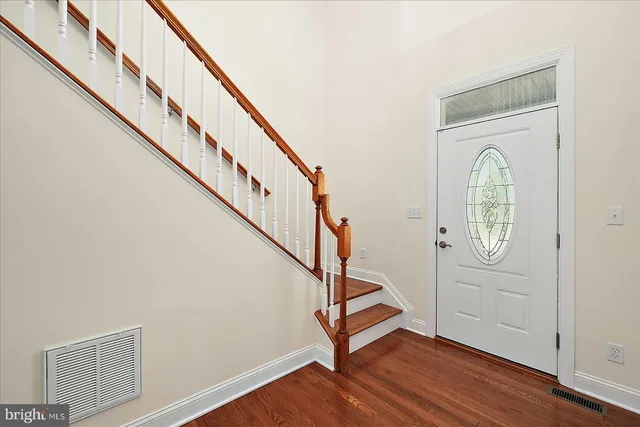 wooden floor in an empty room with a fireplace