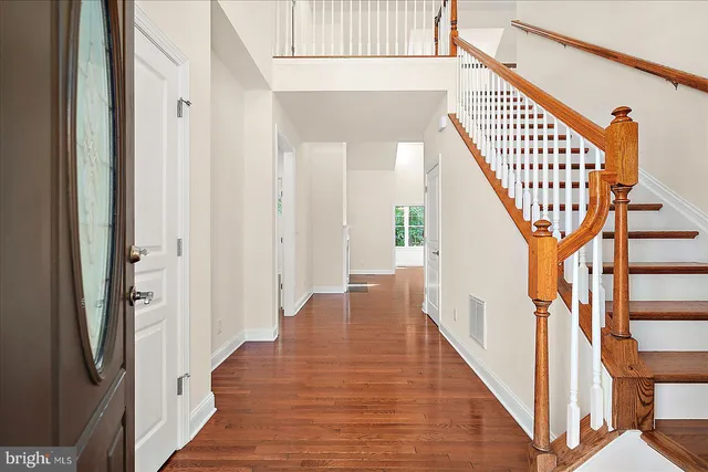 an empty room with windows and a fireplace