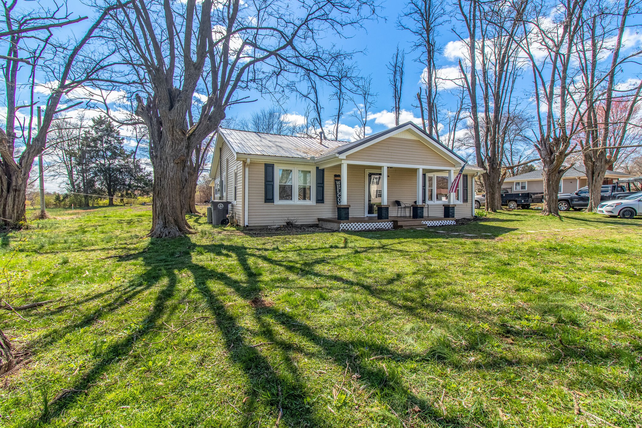 810 Days Road Lafayette, TN 37083 - Photo 1 of 20 a front view of a house with a yard table and chairs
