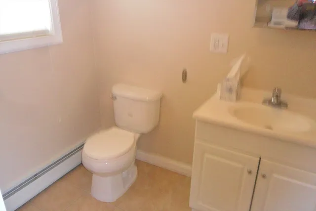 a white toilet sitting next to a bathroom sink
