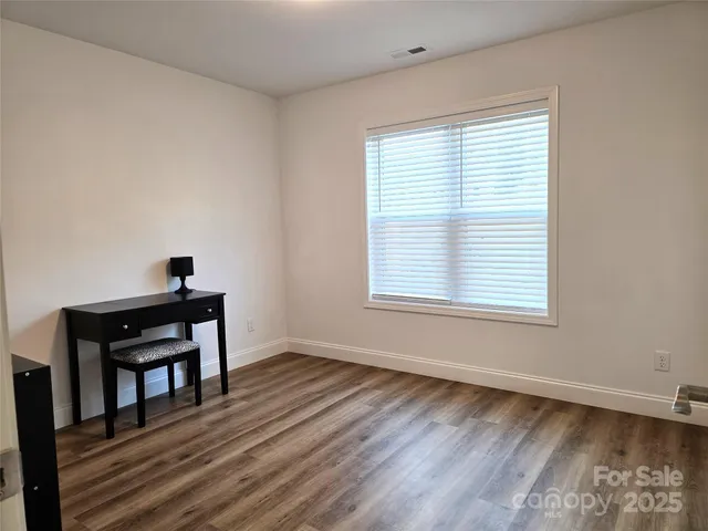 a workspace with wooden floor and a window