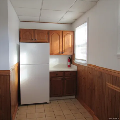 a kitchen with a refrigerator and a sink