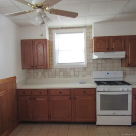a kitchen with granite countertop cabinets stainless steel appliances and a window