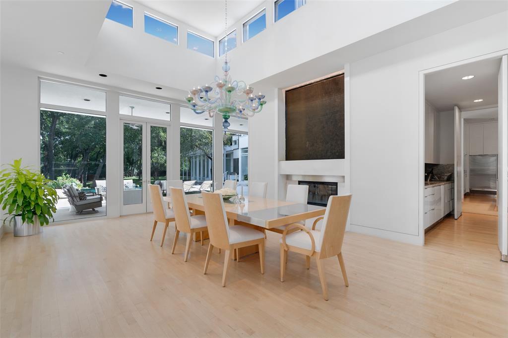 4130 Cochran Chapel Road Dallas, TX 75209 - Photo 14 of 40 a dining room with furniture potted plants and a flat screen tv
