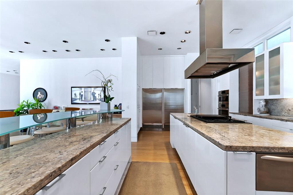4130 Cochran Chapel Road Dallas, TX 75209 - Photo 18 of 40 a kitchen with stainless steel appliances granite countertop a sink and a refrigerator