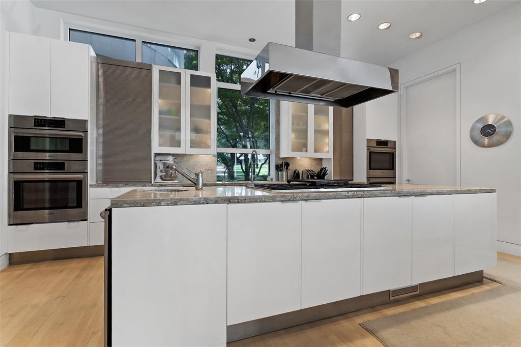 4130 Cochran Chapel Road Dallas, TX 75209 - Photo 19 of 40 a kitchen with stainless steel appliances granite countertop a stove and a refrigerator