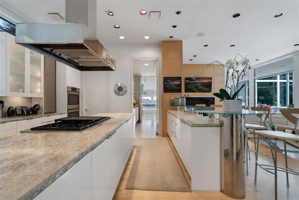 4130 Cochran Chapel Road Dallas, TX 75209 - Photo 20 of 40 a kitchen with stainless steel appliances kitchen island granite countertop a stove and cabinets