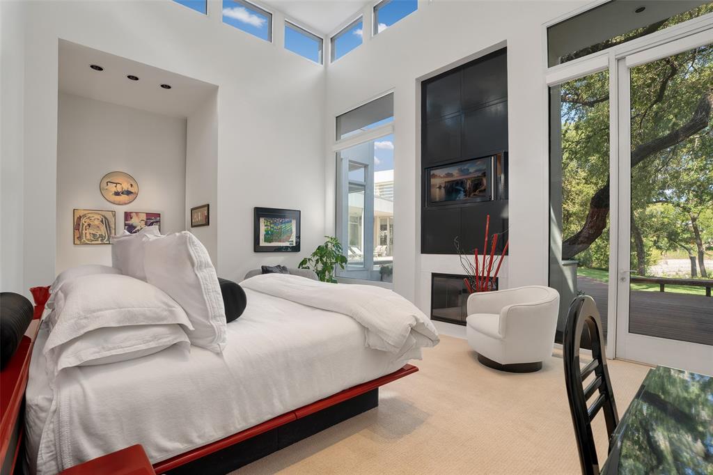 4130 Cochran Chapel Road Dallas, TX 75209 - Photo 25 of 40 a bedroom with a bed and glass window