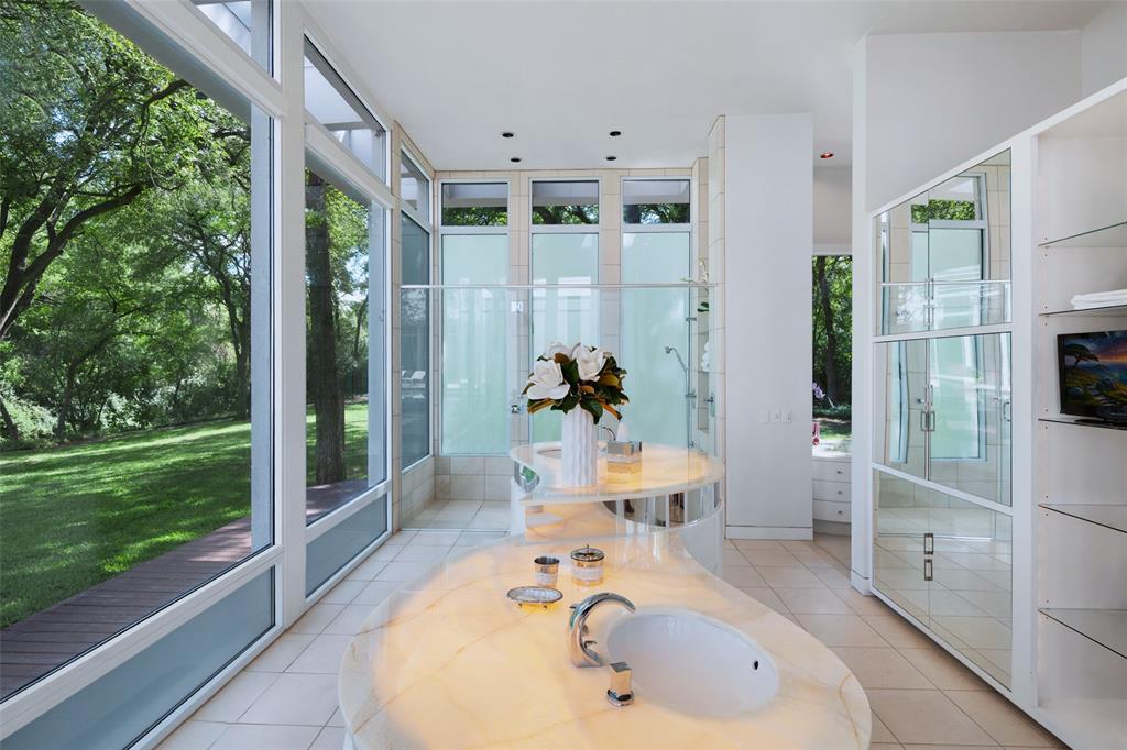 4130 Cochran Chapel Road Dallas, TX 75209 - Photo 27 of 40 a bathroom with a tub sink and mirror
