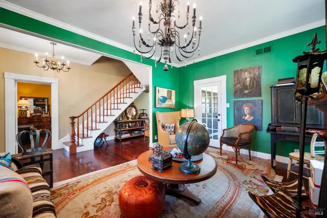 a view of a dining room with furniture and chandelier