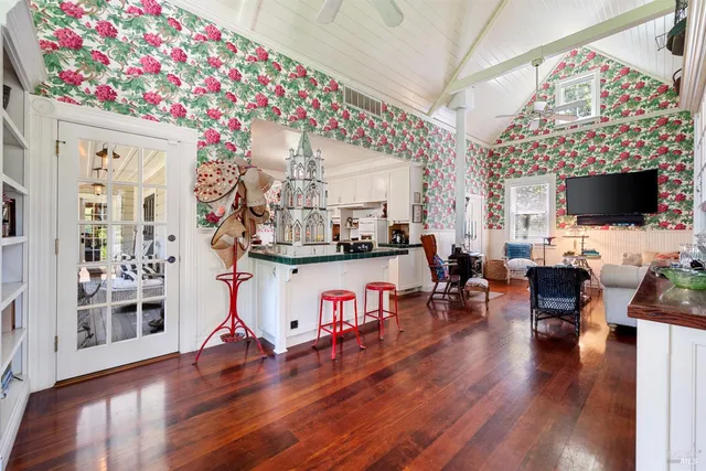 a view of a hallway with wooden floor and windows